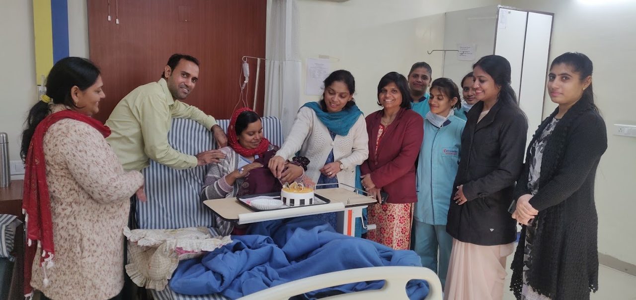 Team celebrating safe delivery with mother